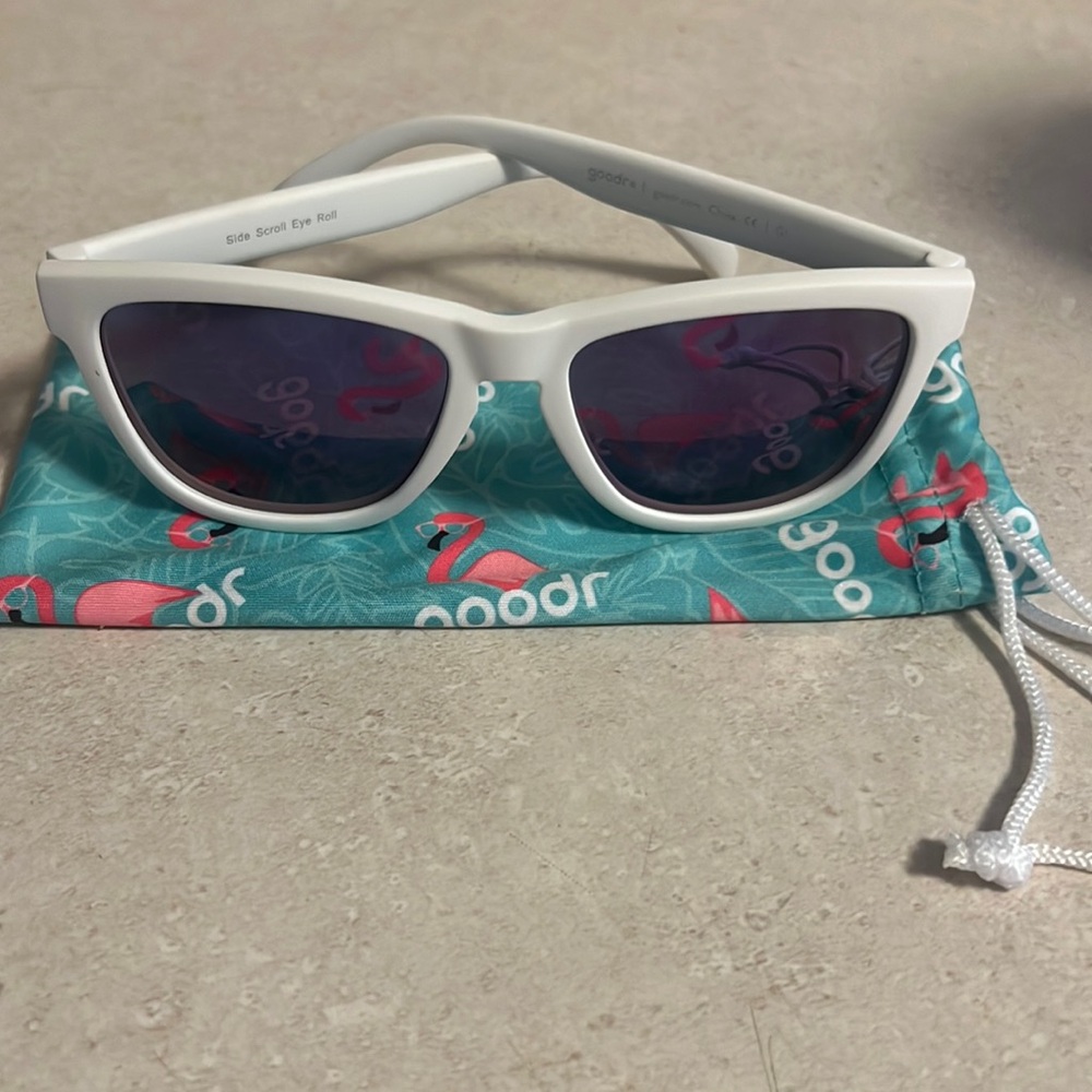 Goodr Side scroll eye roll white frames with a purple tint. Medium size frame